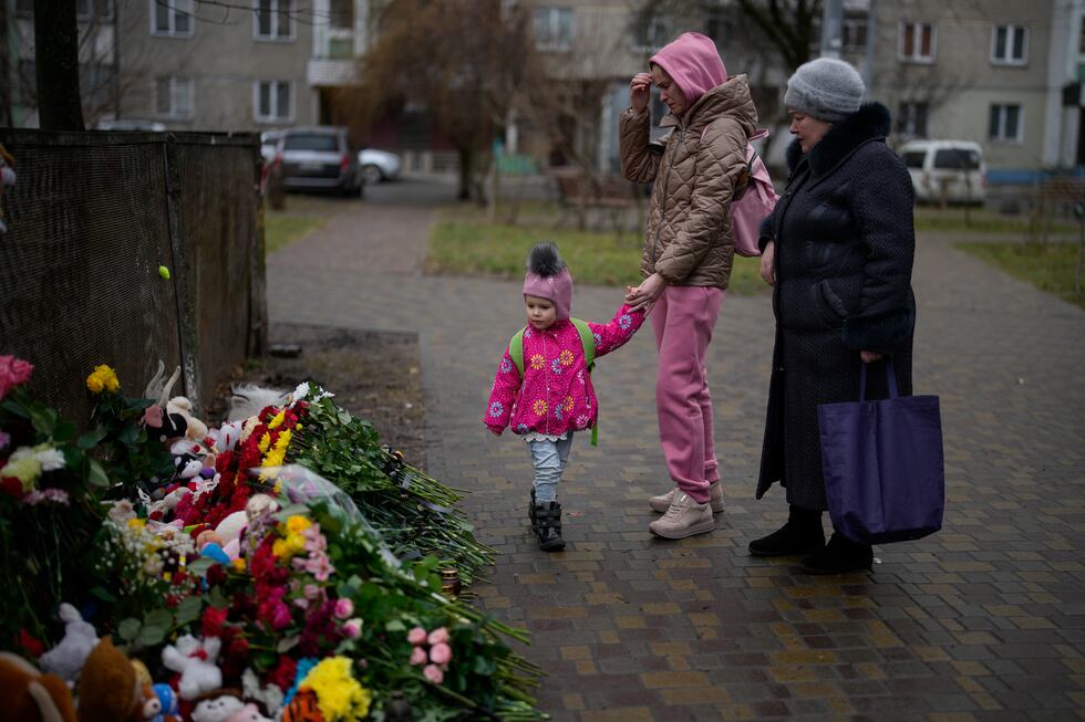 People pay their respects at the scene where a helicopter crashed into civil infrastructure on...