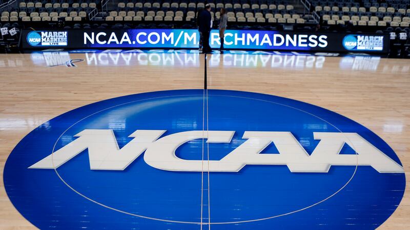 FILE - In this March 18, 2015, file photo, the NCAA logo is displayed at center court at The...