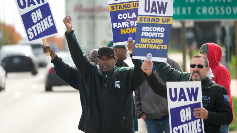 United Auto Workers members walk the picket line during a strike at the Stellantis Sterling...