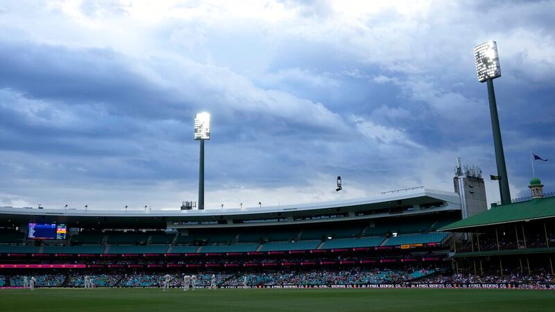 Australia field against England as storm clouds gather above the Sydney Cricket Ground during...