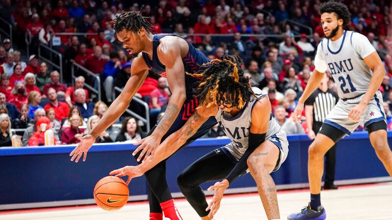 Dayton forward DaRon Holmes II, left, and Robert Morris forward Kahliel Spear, right, fight...